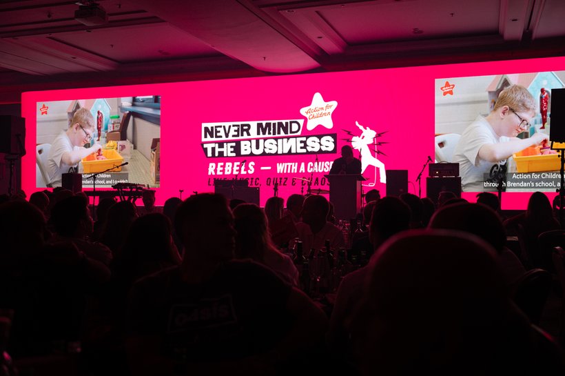 pink media wall displaying image of a child