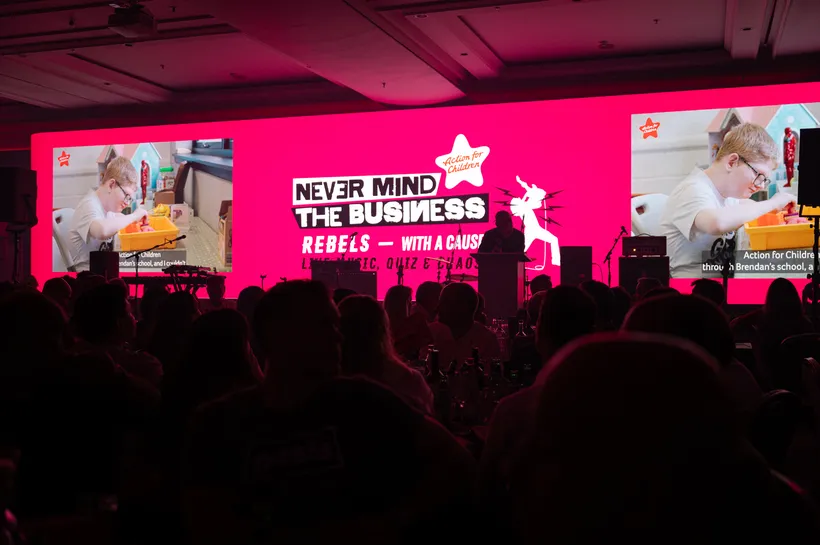 pink media wall displaying image of a child