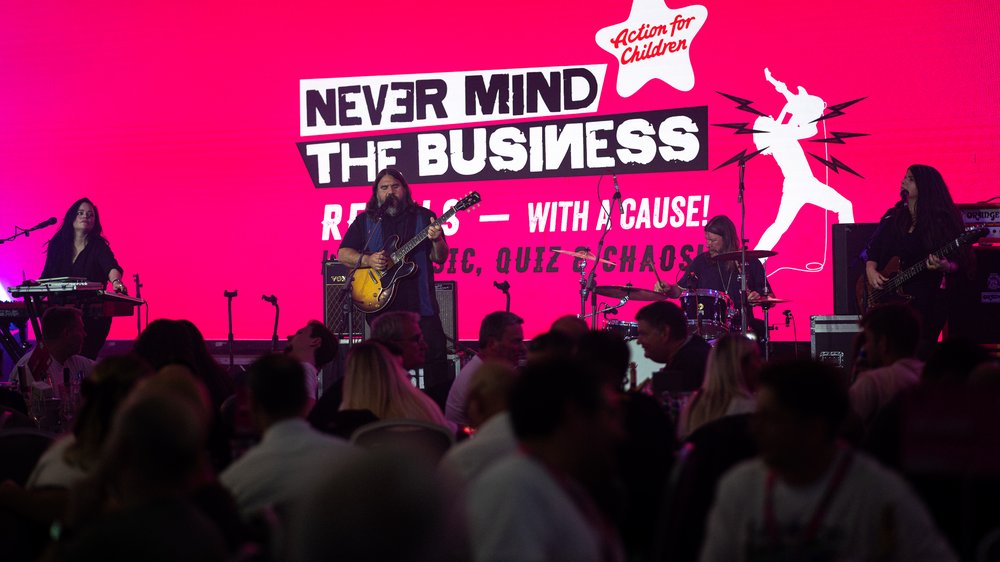 a band called magic numbers sinning on the stage in front of a room full of people