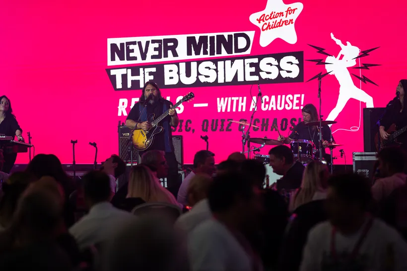 a band called magic numbers sinning on the stage in front of a room full of people