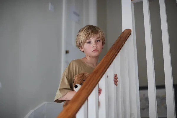 Young boy on stairs in care home