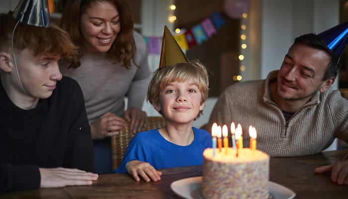 Foster family enjoying a birthday party together, highlighting the positive impact on the whole family