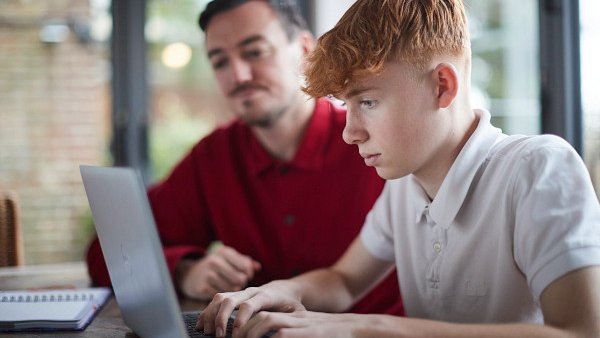 Young person in care studying with their carer