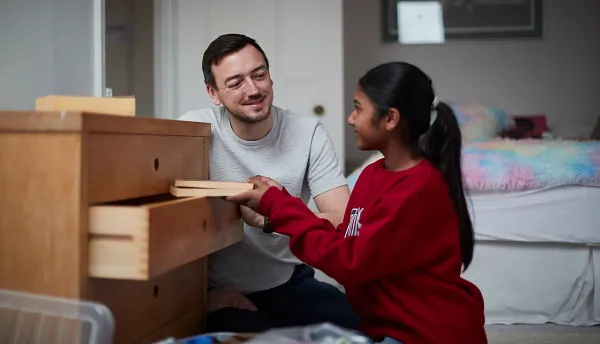 Young person in care unpacking with their carer