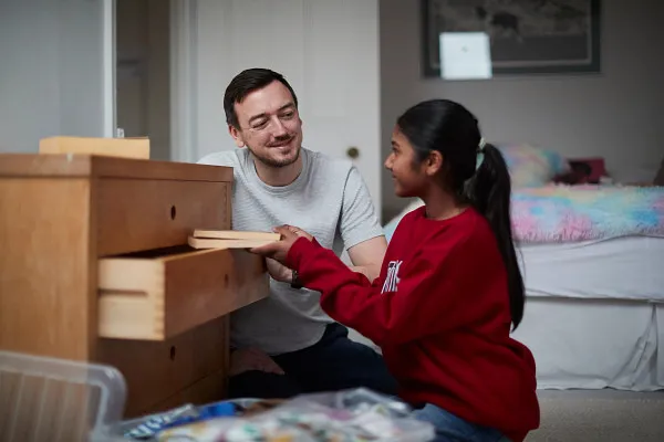 Young person in care unpacking with their carer