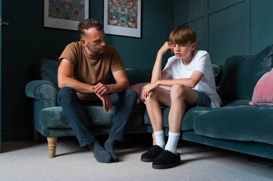 Foster carer offering therapeutic support, listening to a teenage boy during a difficult moment If you want it to lean more toward emotional safety, trust, or therapeutic care, I can shape a few more.