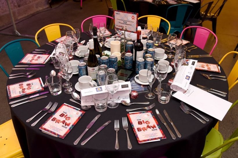 A round dinner table displaying Action for Children's Big Braw Quiz programme