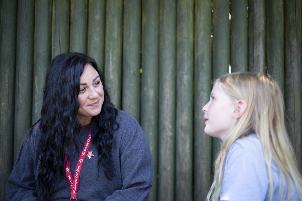 Action for children support worker talking to child