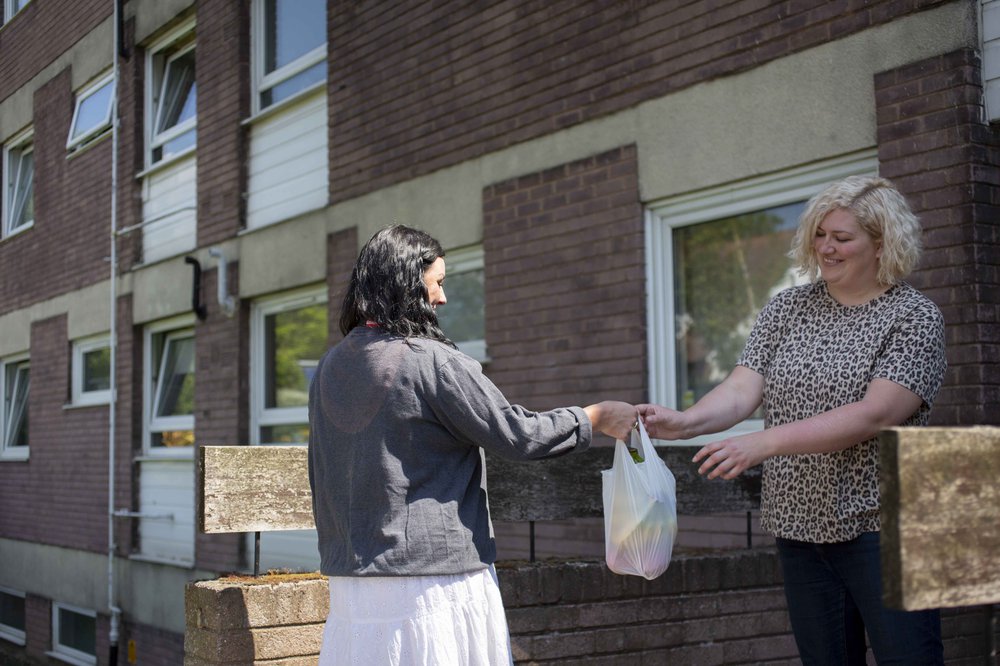 Action for Children support worker giving woman a food package