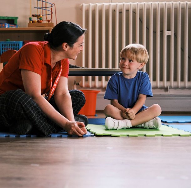 Action for Children worker playing with young boy