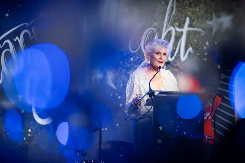 TV Broadcaster, Angela Rippon, presenting on stage at the Starry Night gala