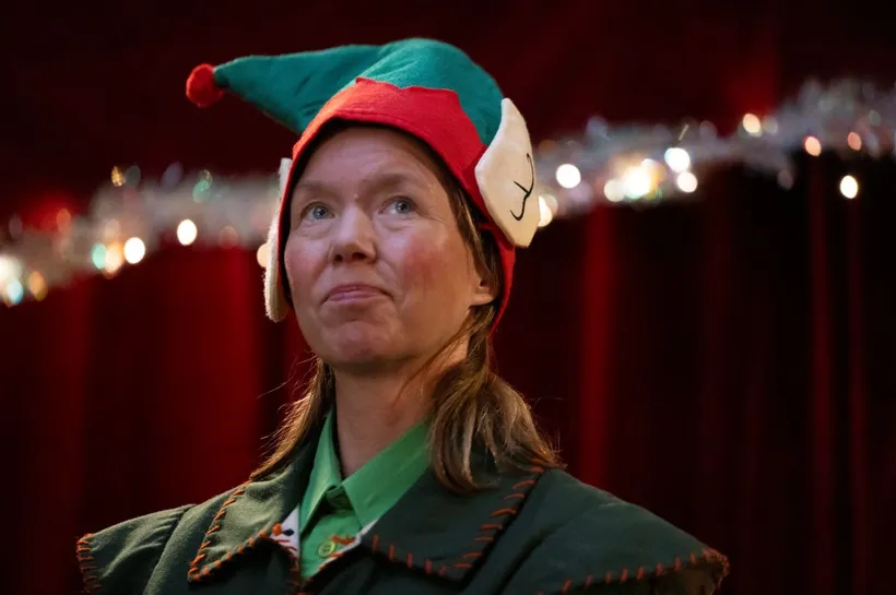 Anna Maxwell-Martin dressed as an elf in Santaland video