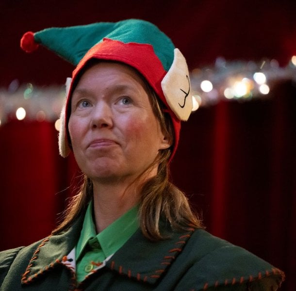Anna Maxwell-Martin dressed as an elf in Santaland video