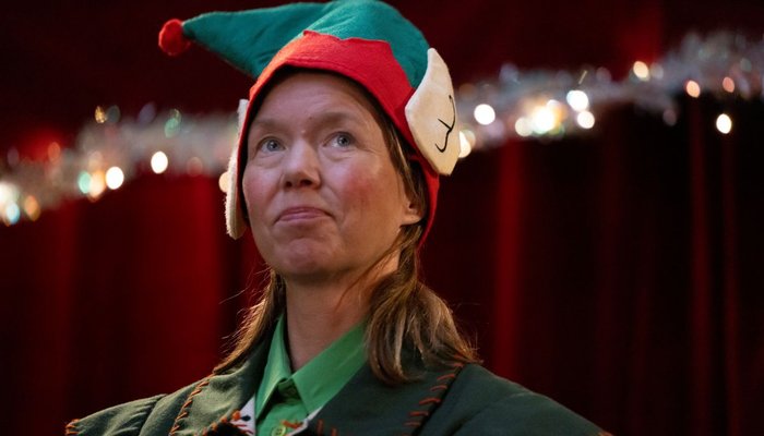 Anna Maxwell-Martin dressed as an elf in Santaland video