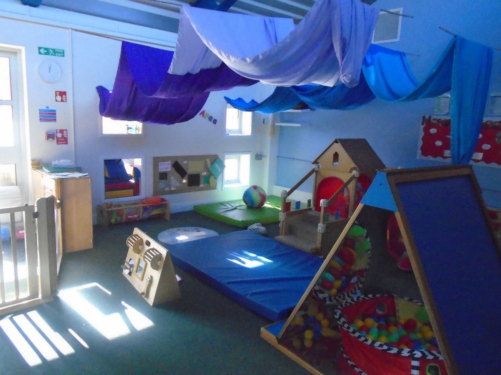 A Mother and Baby Unit in HMP Askham Grance. The nursery is blue, filled with a ball pit, mats, and different toys and activities for the mother and baby