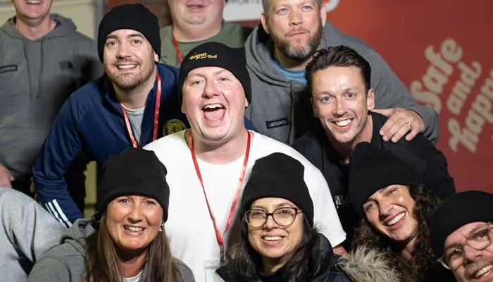 Group of people laughing and smiling at a Boycott your Bed event