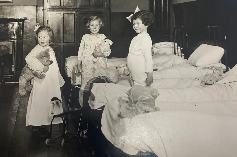 Black and white image of three girls dressed for bed