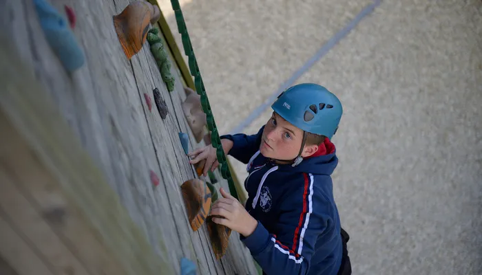 Boy climbing wall at the Bucks Activity Project