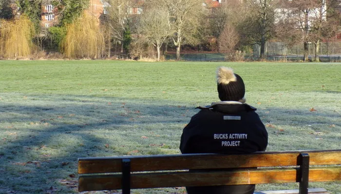 Bucks Activity Project team member sitting on a bench and landscape view