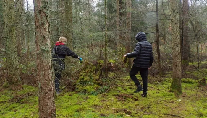 Two young people in the woods on a rainy day at the Bucks Activity Project