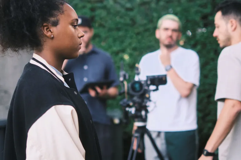 Chan filming for Action for Children's new film, with the videographer team in the background