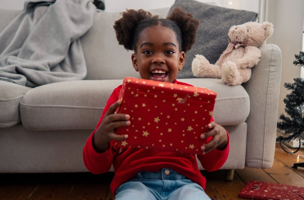 Chloe holding a present and smiling