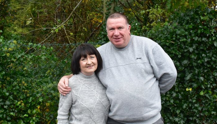 - Colin and Marie holding each other, showing the love and faith that support their fostering through their church