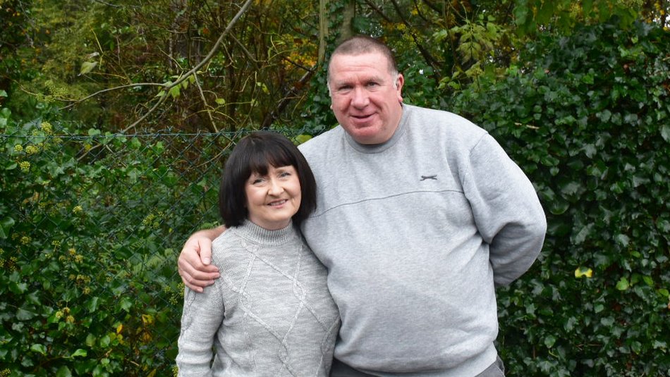 - Colin and Marie holding each other, showing the love and faith that support their fostering through their church