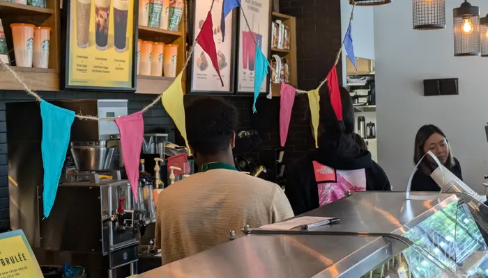 Young people doing work experience in a cafe