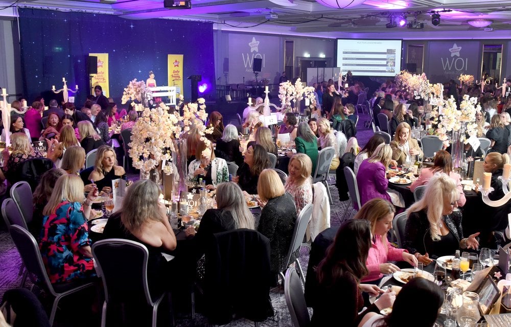A ballroom filled with mostly female guests seated at tables for the Women of Influence Awards
