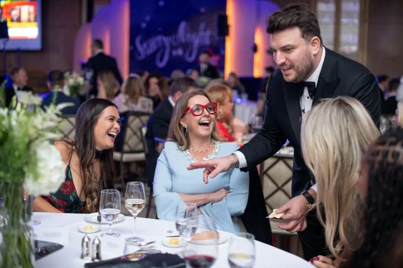 Magician and Britain's Got Talent Finalist, Darren Sarsby, performing magic to a group sitting at the table