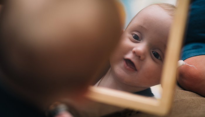 baby looking in a mirror