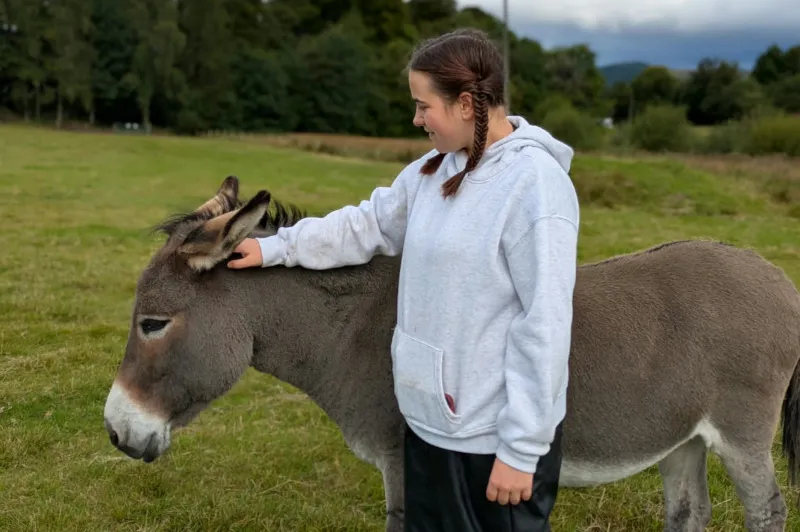 Emily with a horse at equine therapy