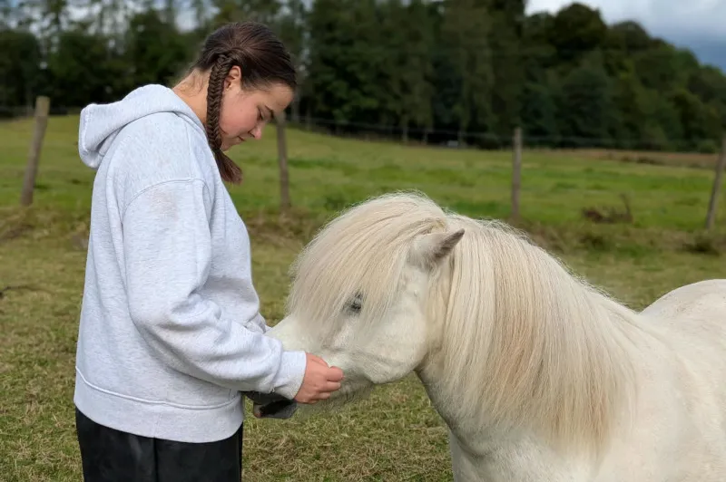 Emily with a horse at equine therapy