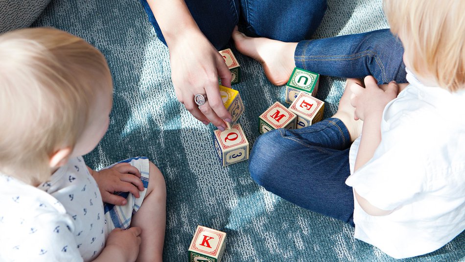 Family playing with letter blocks