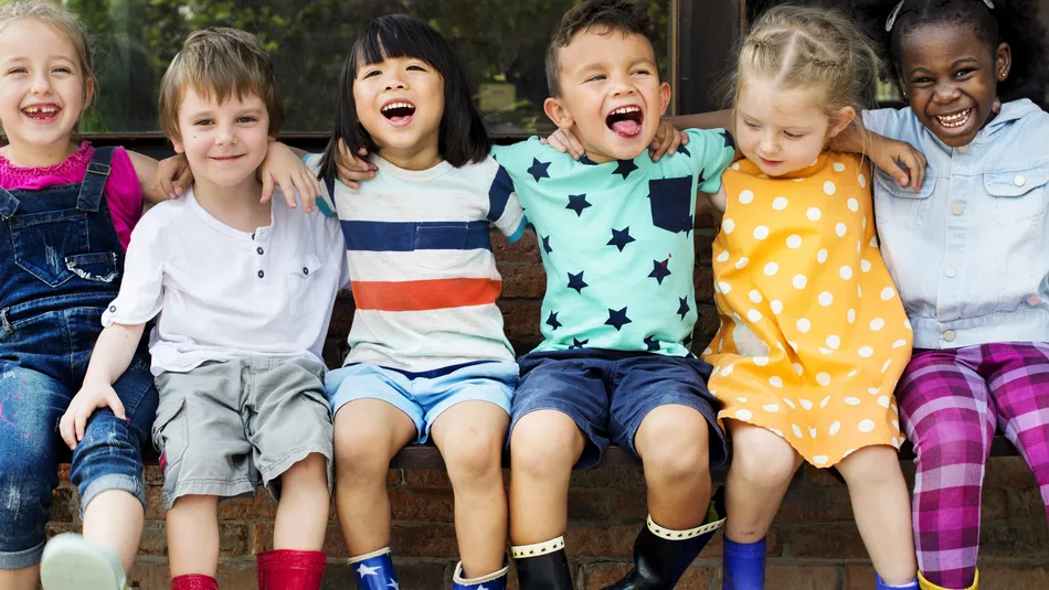 Group of children sitting and smiling fun