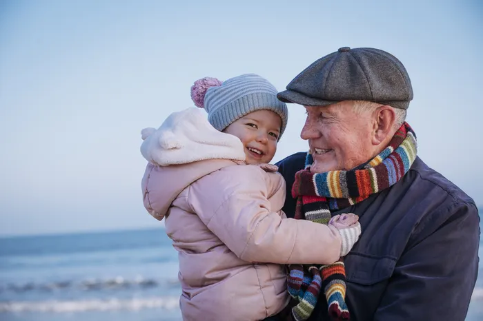 Happy grandpa holding grandaugther