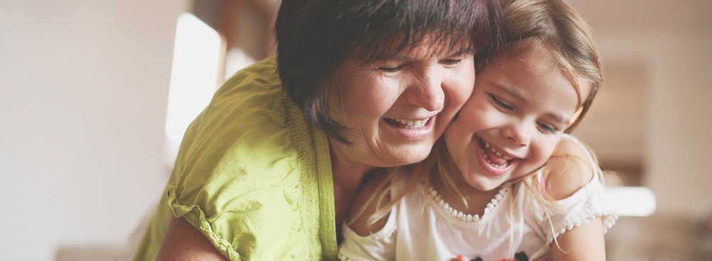 Happy mother and daughter playing on iPad