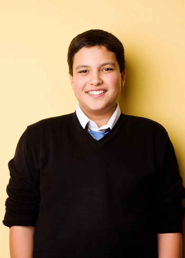 Portrait of happy teenage boy student