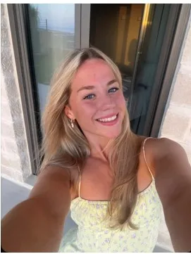 Young Ambassador Hollie, holding the camera and smiling