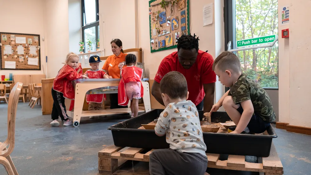 Jerome playing with children at nursery