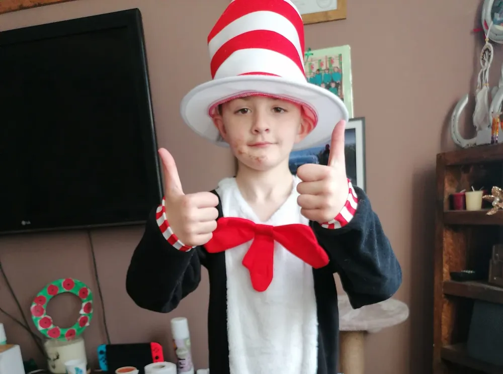 Joel wearing a Cat in the Hat costume. He is giving a thumbs up to the camera.