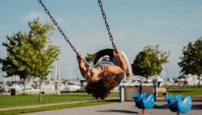 Joyful girl on swing