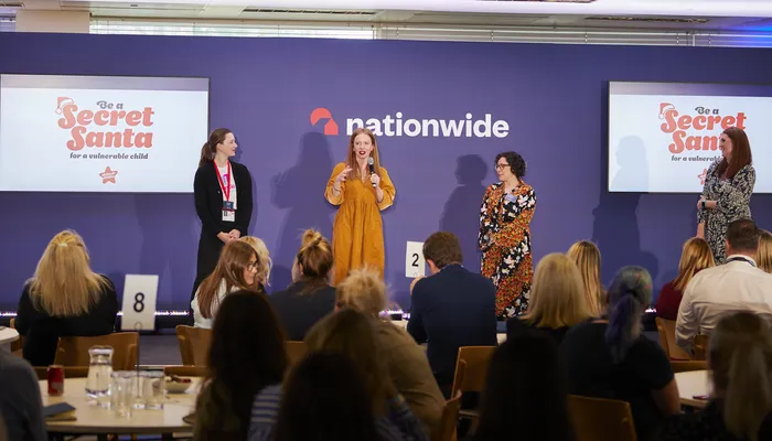 Katherine Woods speaking onstage at a Nationwide event