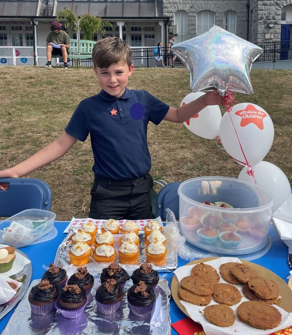 AFC fundraiser Leo selling homemade cakes at his school fair