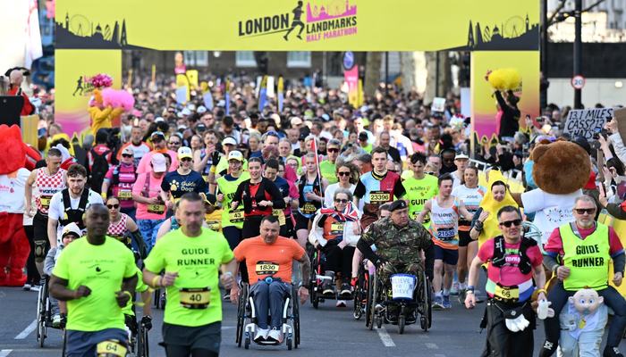 Runners running through the starting point at the London Landmarks Half Marathon