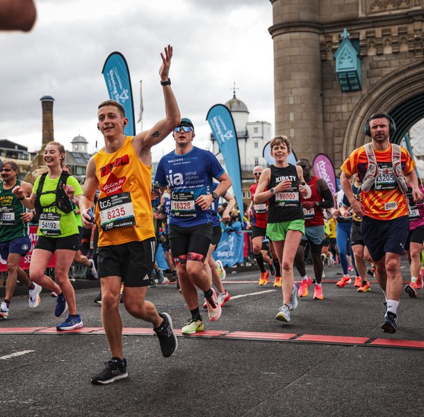 Action for Children runner crossing tower bridge at the London Marathon