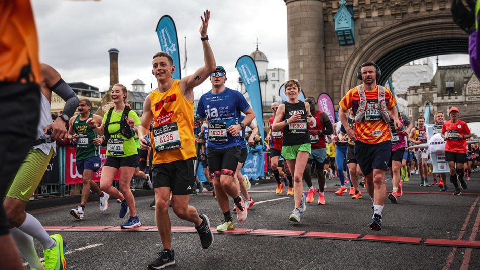Action for Children runner crossing tower bridge at the London Marathon