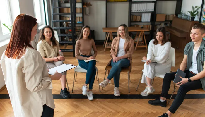 Medium shot people sitting on chairs