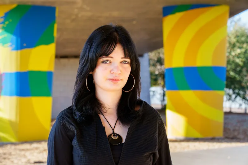 Young woman in urban setting wearing black shirt